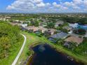 Aerial view of a house with a pool, in a neighborhood with a lake at 8108 Haven Harbour Way, Bradenton, FL 34212