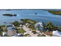 Aerial view of waterfront home and surrounding neighborhood at 1910 Oregon Trl, Englewood, FL 34224
