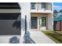 Modern home's entryway with stone and glass door at 2111 Hawthorne St, Sarasota, FL 34239