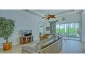 Spacious living room with leather sofas, large windows, and access to a patio at 12327 Thornhill Ct, Lakewood Ranch, FL 34202