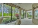 Relaxing screened porch overlooking the backyard with patio furniture at 12327 Thornhill Ct, Lakewood Ranch, FL 34202