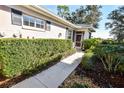 Inviting walkway to the villa entrance, surrounded by lush greenery at 909 Barclay Ct, Venice, FL 34293