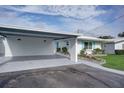 Covered carport with attached storage and a nicely landscaped front yard at 1810 University Pl # 6, Sarasota, FL 34235