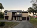 Two-story home with attached garage and balcony at 1210 Casey Key Rd, Nokomis, FL 34275