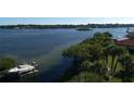 Waterfront property with boat dock and lush landscaping at 1210 Casey Key Rd, Nokomis, FL 34275