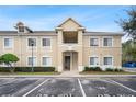Tan two-story condo building with stairs and landscaping at 9505 Amberdale Ct # 201, Riverview, FL 33578