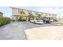 Exterior view of a townhome building with parking spaces in front at 26356 Nadir Rd # 101, Punta Gorda, FL 33983