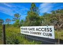 Sign indicating private gate access to the country club at 34452 Singletary Rd, Myakka City, FL 34251