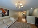 Open living room with hardwood floors and a cozy seating area at 8807 White Sage Loop # 1903, Lakewood Ranch, FL 34202