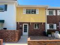 Townhome with brick and yellow siding, private entrance at 705 W Venice Ave # 705-B, Venice, FL 34285