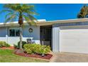 Light blue home with white garage door and landscaping at 3721 Somerville Dr # 1513, Sarasota, FL 34232