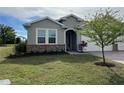 Landscaped front yard with a neutral-colored exterior at 2275 Hamburg Ln, Punta Gorda, FL 33983