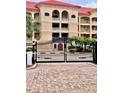 Building exterior with gated entrance and Mediterranean style at 7612 Lake Vista Ct # 305, Lakewood Ranch, FL 34202