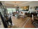 Spacious living room with hardwood floors, large windows, and elegant furnishings at 7612 Lake Vista Ct # 305, Lakewood Ranch, FL 34202