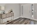 Bright entryway with light gray wood-look flooring and console table at 4512 Ulster Ave, North Port, FL 34287