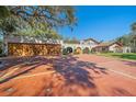 Spanish style home with a three car garage and circular driveway at 4674 Hidden River Rd, Sarasota, FL 34240