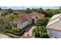 An aerial view showcasing a house and its surrounding neighborhood at 5814 Benevento Dr, Sarasota, FL 34238