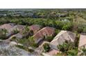 Aerial view of a house nestled in a community of similar homes at 5814 Benevento Dr, Sarasota, FL 34238