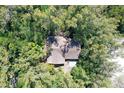 House nestled in lush greenery, seen from above at 600 Dream Island Rd, Longboat Key, FL 34228