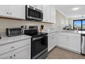 Modern kitchen with white cabinets, stainless steel appliances, and quartz countertops at 17510 Gawthrop Dr # 403, Bradenton, FL 34211