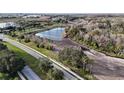 Aerial view of a construction site near a lake and roads at 7990 Stone Harbour Loop, Bradenton, FL 34212