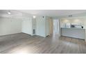 Bright living room featuring hardwood floors and updated kitchen at 4576 Ringwood Mdw # 5, Sarasota, FL 34235