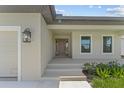 Front entrance with steps leading to a covered porch at 196 Arch Dr, Rotonda West, FL 33947