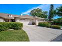 Charming single-story home with a two-car garage, well-maintained lawn, and lovely curb appeal at 4115 Putter Pl # 4115, Bradenton, FL 34203