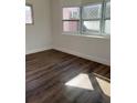 Bedroom with laminate flooring, natural light from the window, and fresh white paint at 2601 Gulf N Dr # 603, Bradenton Beach, FL 34217