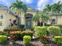 Landscaped front yard with tropical plants and a welcoming entrance at 14708 Sundial Pl, Lakewood Ranch, FL 34202