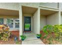 Condo entrance with a black door and landscaping at 4395 Rayfield Dr # C-3111, Sarasota, FL 34243