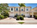 Two-story house with tan exterior, balcony, and attached garage at 1749 Burgos Dr, Sarasota, FL 34238