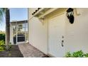 White front door with sidelights and a brick walkway leading to the entrance at 1749 Burgos Dr, Sarasota, FL 34238