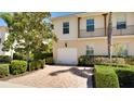 Two-story house with tan exterior, balcony, and attached garage at 1749 Burgos Dr, Sarasota, FL 34238