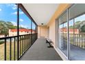 Screened balcony with outdoor seating, offering views of the pool and surrounding area at 209 Rubens Dr # E, Nokomis, FL 34275