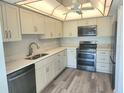 Modern kitchen with white cabinets, quartz countertops, and stainless steel appliances at 5188 Marsh Field Ln # 93, Sarasota, FL 34235