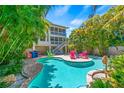 Freeform pool surrounded by tropical plants at 508 Spring Ave, Anna Maria, FL 34216