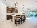 Modern kitchen with island and stainless steel appliances at 8678 Rain Song Rd, Sarasota, FL 34238