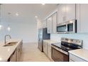 Stainless steel appliances and white cabinets in this kitchen at 1575 Laurel Brook Ln, Port Charlotte, FL 33953