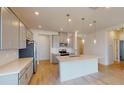 Modern kitchen featuring gray cabinets, quartz countertops, and stainless steel appliances at 16113 Old Fox Trl, Port Charlotte, FL 33953