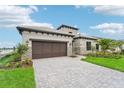 Two-story home with modern design and a stone facade at 524 Bocelli Dr, North Venice, FL 34275