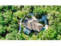 Aerial view of a home nestled in a lush wooded area at 22310 Taylor Dr, Bradenton, FL 34211