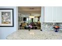 Kitchen with granite countertops, open to dining and living areas at 1215 S Portofino Dr # 308, Sarasota, FL 34242