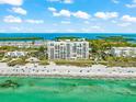 Aerial view of oceanfront building and beach at 4401 Gulf Of Mexico Dr # 704, Longboat Key, FL 34228