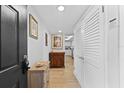 Bright condo entryway with wood cabinet at 4401 Gulf Of Mexico Dr # 704, Longboat Key, FL 34228