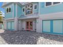 Front entrance with double doors and unique artistic accents at 118 Mangrove Ave, Anna Maria, FL 34216