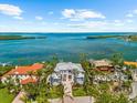 Breathtaking aerial view showcases a beautiful waterfront estate with lush greenery and stunning bay access at 757 Hideaway Bay Dr, Longboat Key, FL 34228