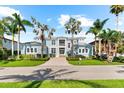 Beautiful two-story home with a manicured lawn, charming facade, and a welcoming entrance way at 757 Hideaway Bay Dr, Longboat Key, FL 34228