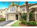 Townhouse exterior featuring a two-car garage and landscaping at 7632 Plantation Cir, Bradenton, FL 34201