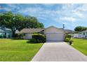 This lovely home features a large yard and a two-car garage at 9390 Gulfstream Blvd, Englewood, FL 34224